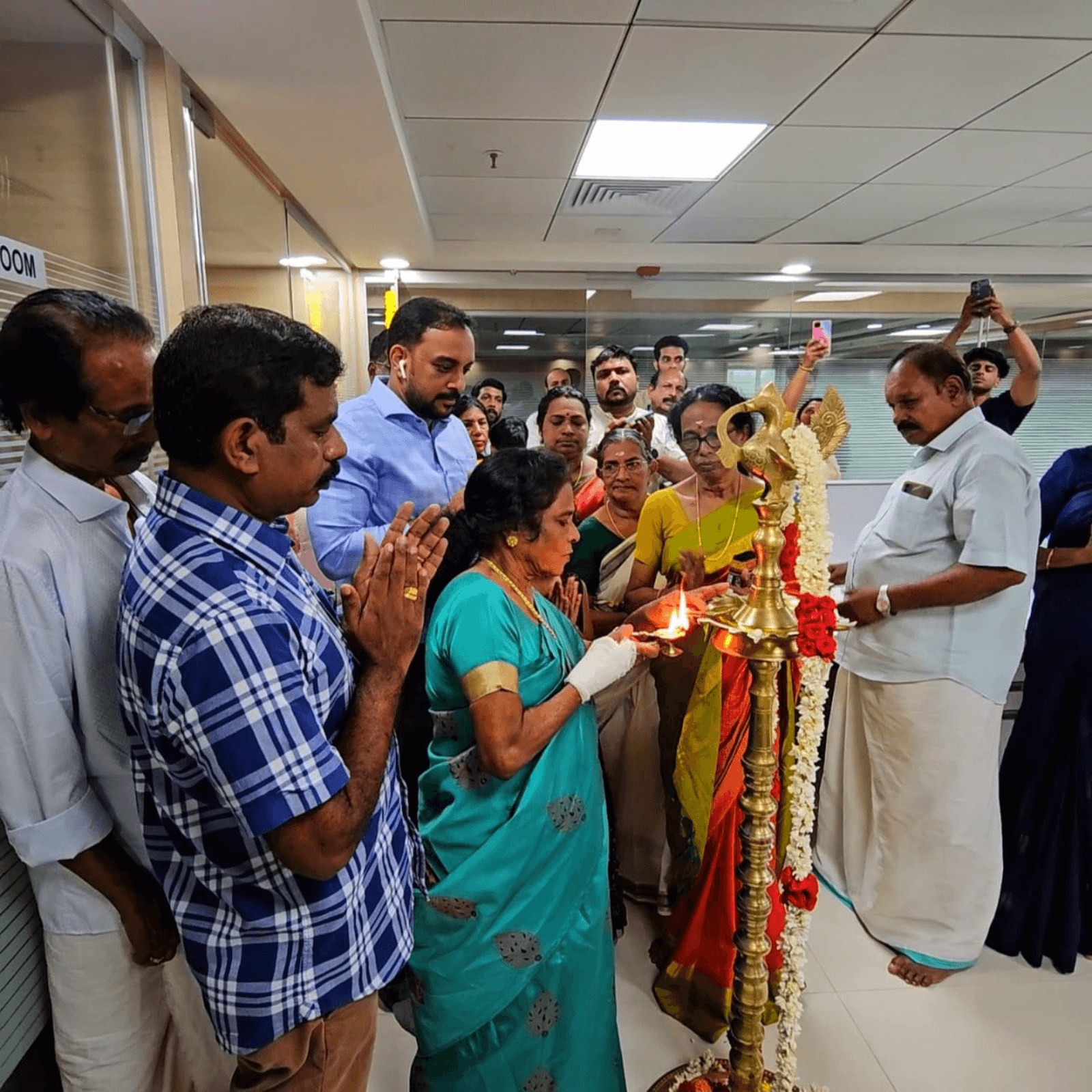 The lighting of the ceremonial lamp to signify the launch of BizData Tech Consultancy's office at Technopark Kollam.